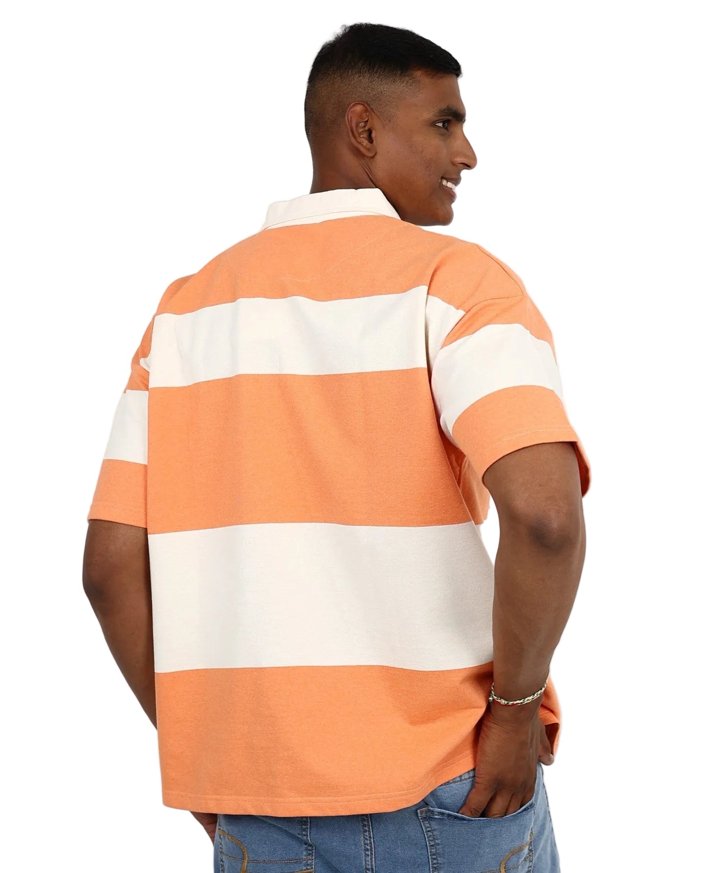 Man wearing an orange and white striped polo shirt on a plain background