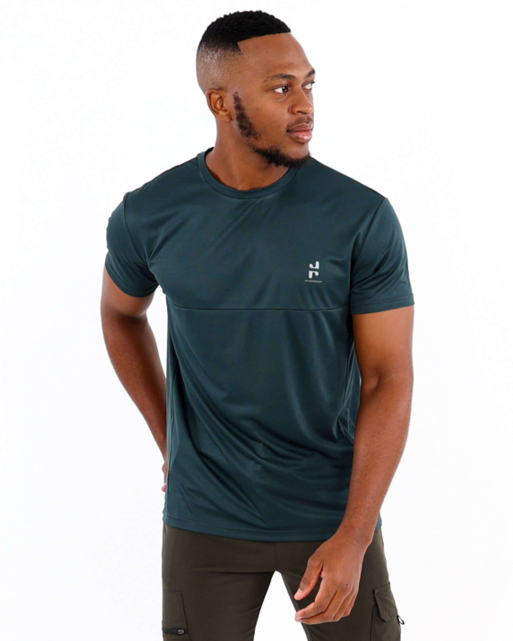 A man wearing a green Active T-shirt and dark trousers, standing against a white background.