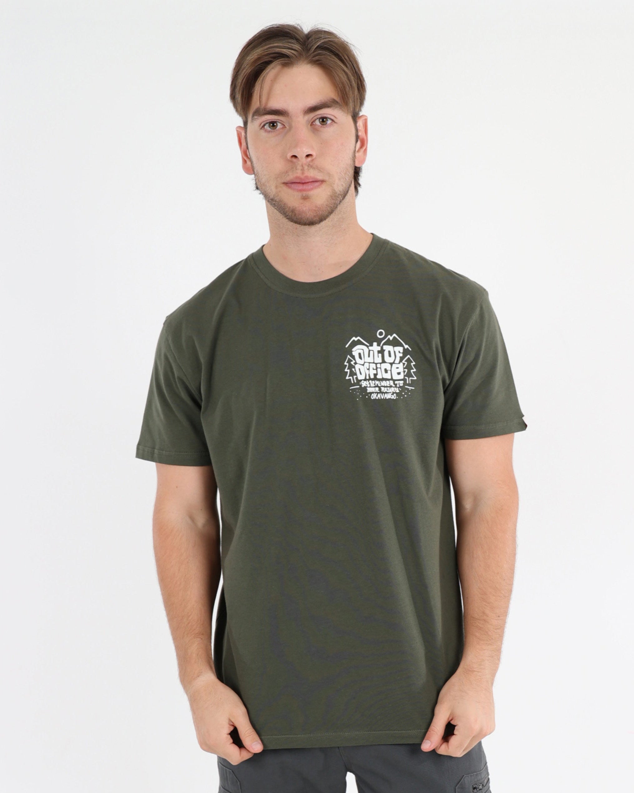 Man wearing a green t-shirt and gray cargo pants on a white background